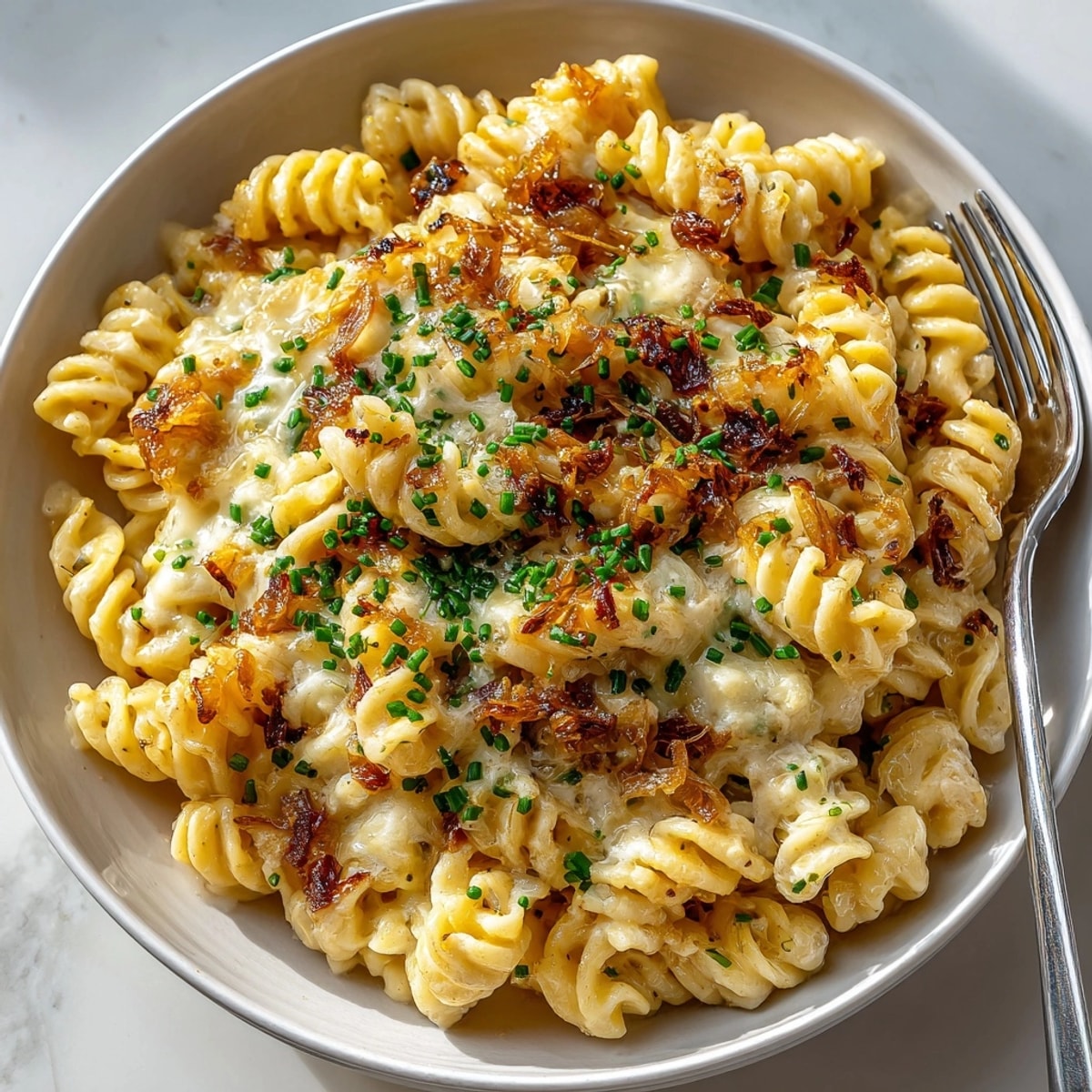 Tender pasta and flavorful caramelized shallots combine in this easy One-Pan French Onion Pasta recipe.