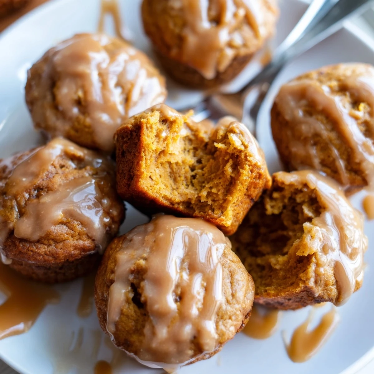 Delicious pumpkin muffins with smoky maple glaze, perfect for fall baking.  
