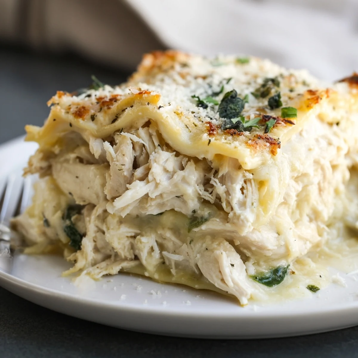 Savory rosemary chicken lasagna served hot, layered with creamy béchamel and mozzarella.  