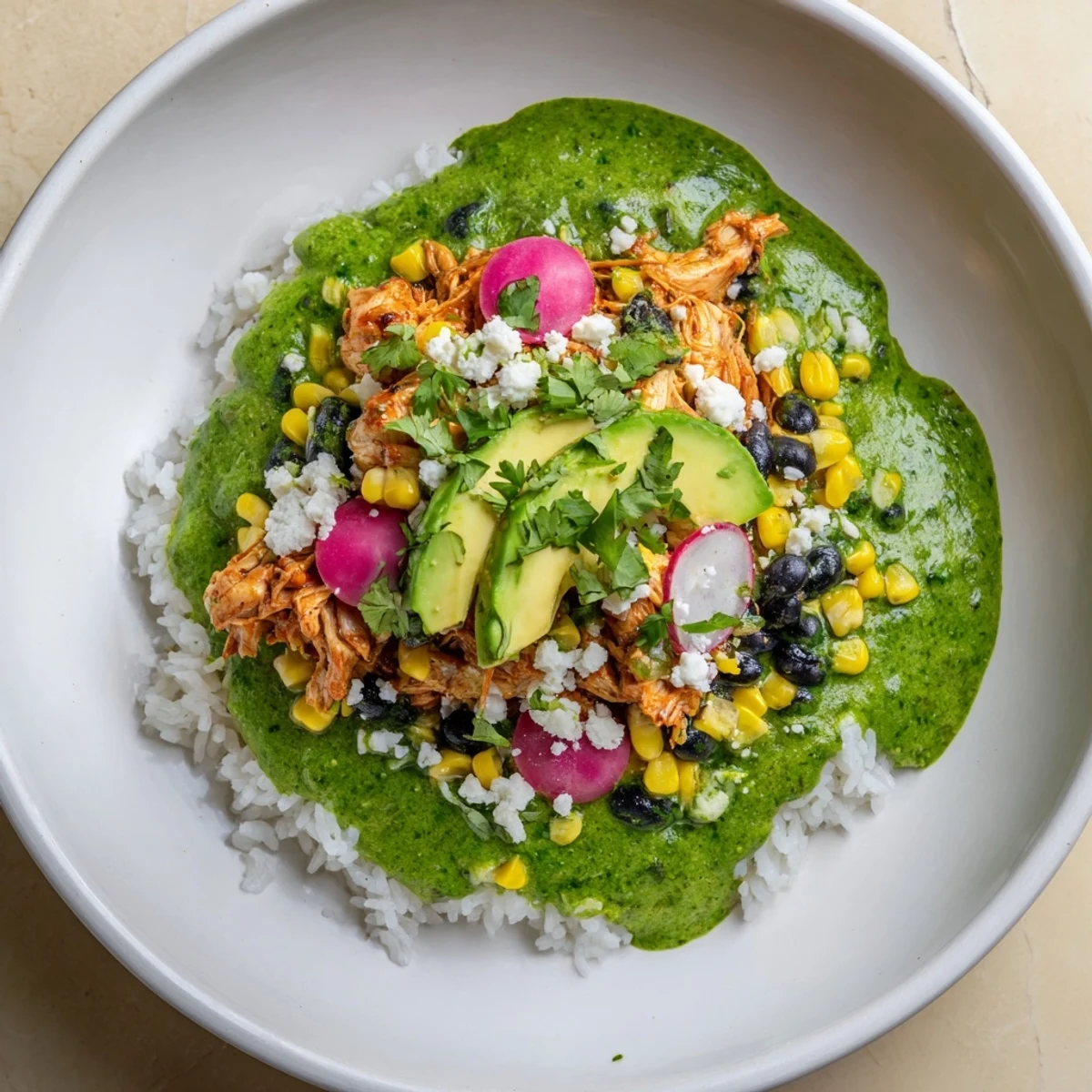 View a flavorful Green Enchiladas Rice Bowl, showcasing a vibrant Tex-Mex meal with avocado slices.