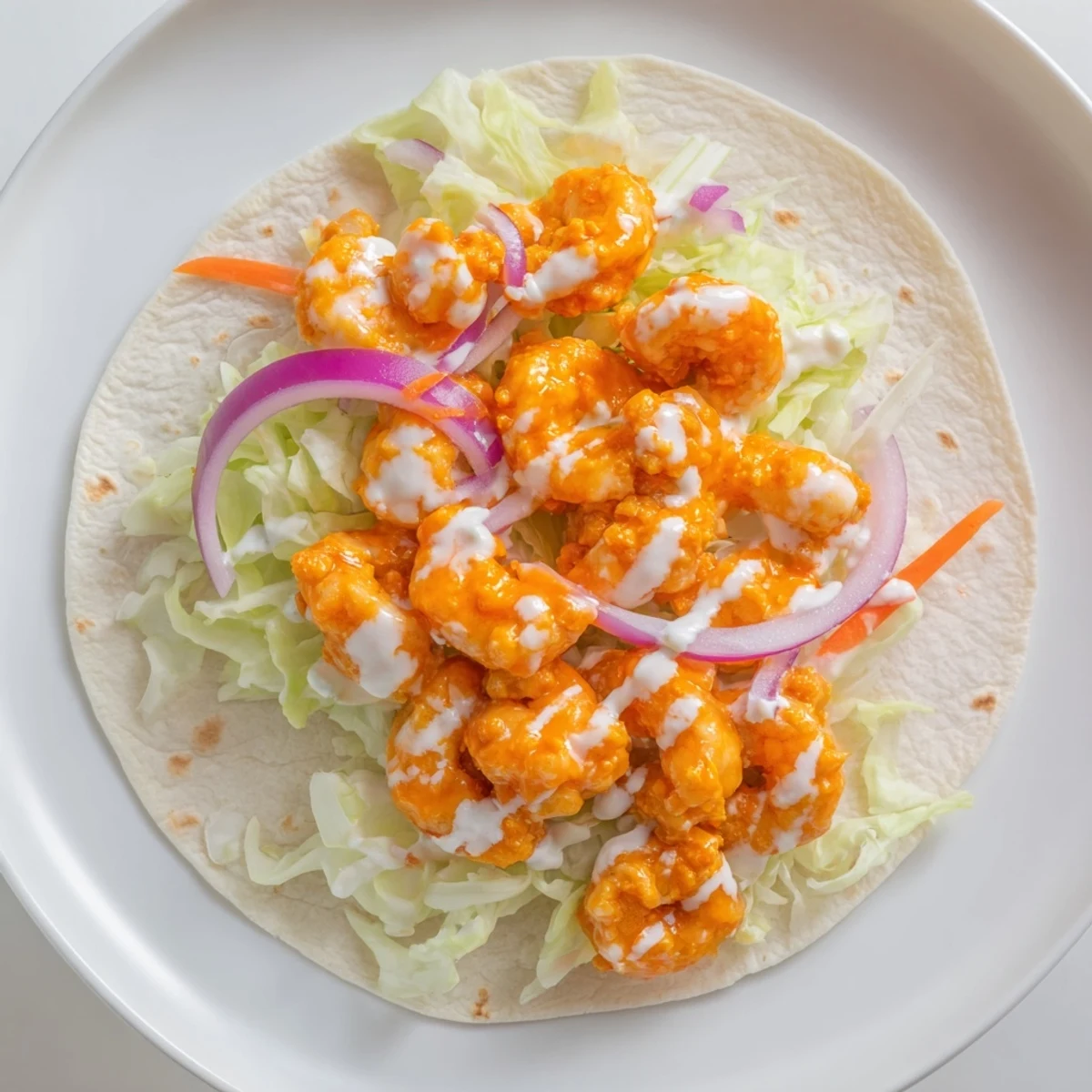Tempting close-up of vibrant Buffalo Shrimp Wraps filled with crispy veggies and creamy dressing.