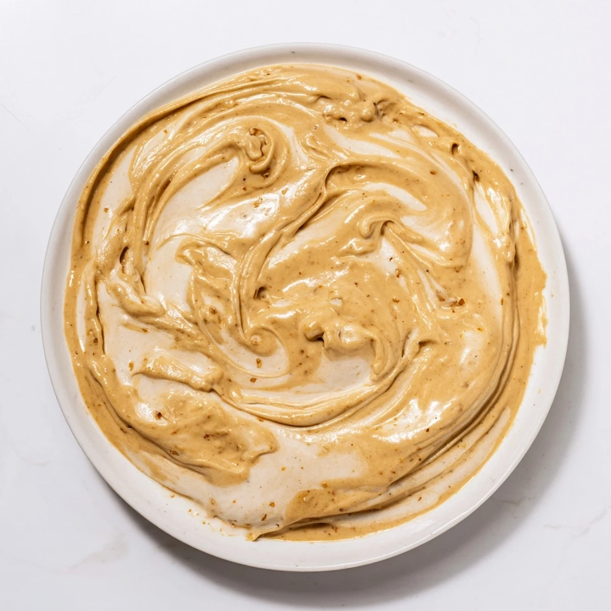 Creamy Peanut Butter Banana Ice Cream swirled with smooth peanut butter, ready to scoop and enjoy.