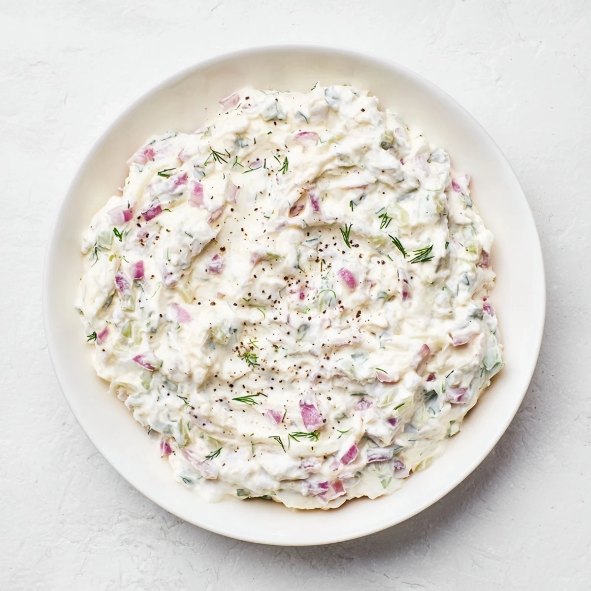 Scooping the vibrant sweet and sour pickle relish dip with tortilla chips for a tasty appetizer.