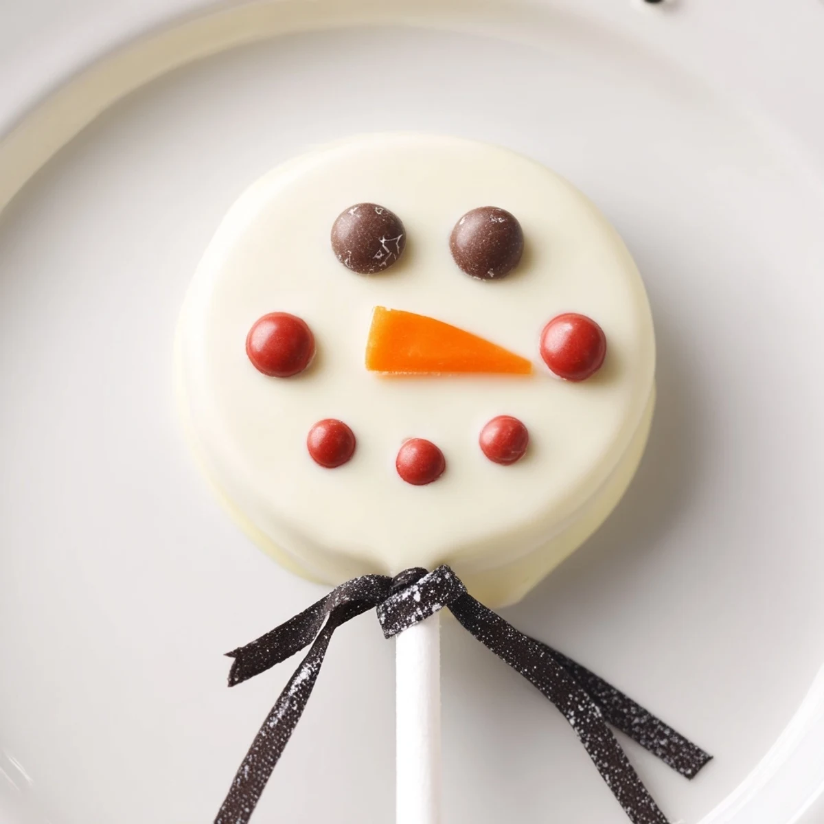These festive Budget-Friendly Oreo Snowman Pops feature perfectly dipped, sweet chocolate with bright smiles.