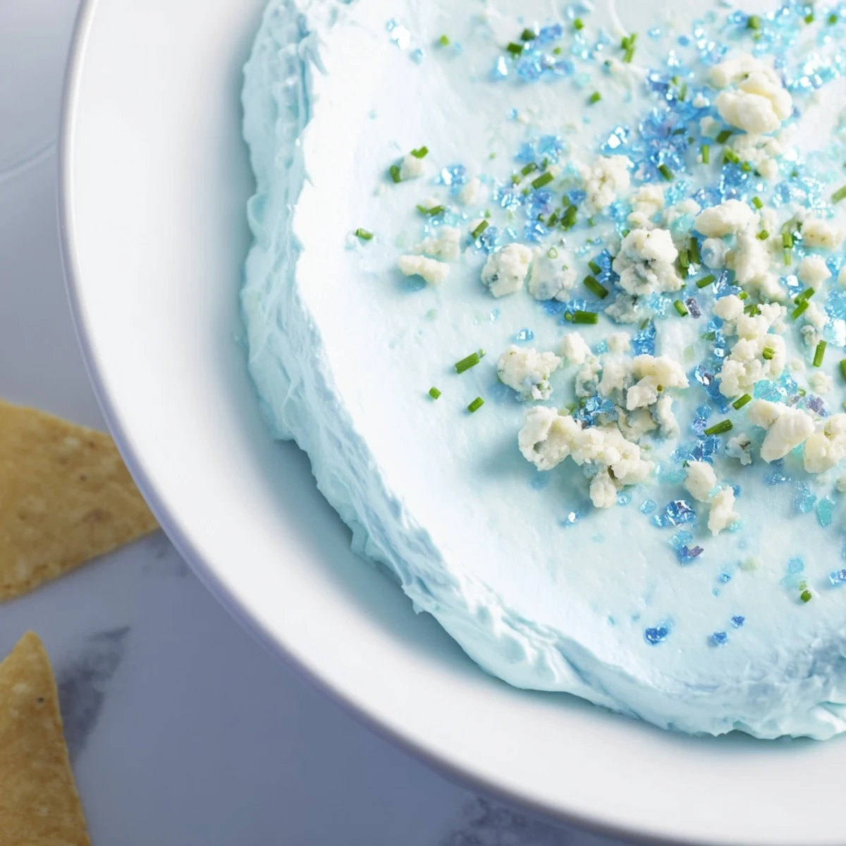 Frozen Pond Blue Dip Platter, a stunning icy blue dip with colorful chips and crisp veggies.