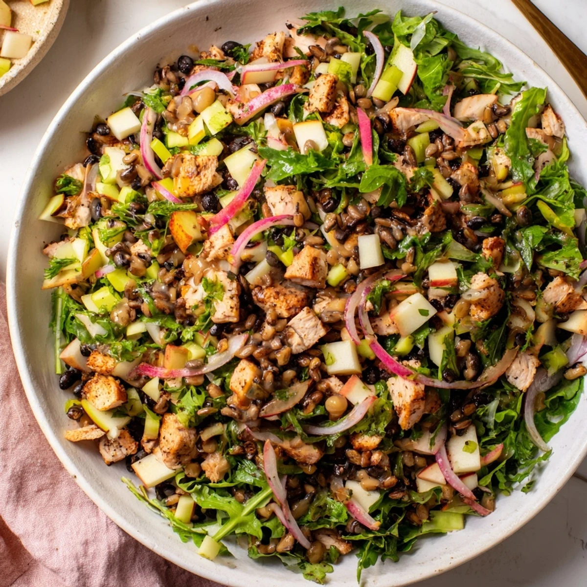 Chicken and Apple New Years Luck Salad, a colorful mix of chicken, apples, and black-eyed peas topped with toasted pecans.