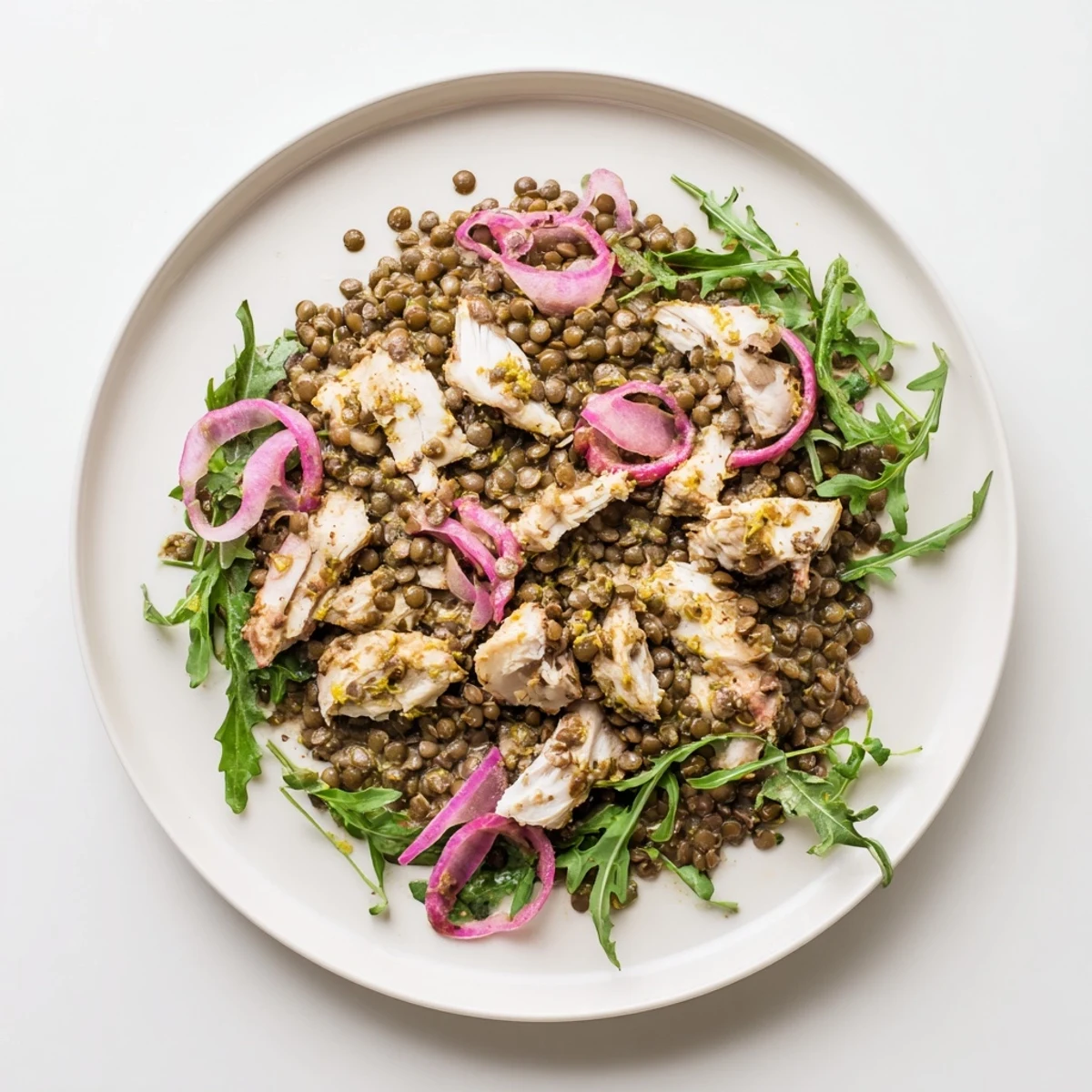 Serving suggestion for the Lentil & Chicken Spring Salad, plated with optional cucumber slices and a sprinkle of peppery arugula for a refreshing meal.