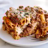 Delicious Baked Ziti with Meat Sauce layered with rich flavors and gooey cheese goodness.  