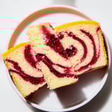 This Cranberry Orange Swirl cake boasts a moist crumb and festive cranberry-orange swirls.