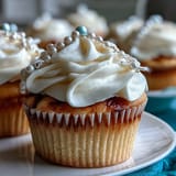 Mini First Communion Cupcakes with Rosary Fondant Toppers, delicate vanilla treats frosted with smooth buttercream and topped with edible fondant rosary designs.