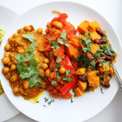 Vibrant Indian Chickpea Curry simmering in a skillet, garnished with fresh cilantro.  