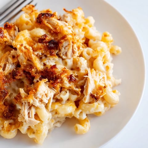 Creamy Classic Mac & Cheese with BBQ Chicken, bubbling golden crust on top.  