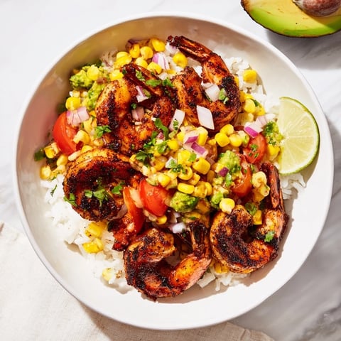 Skillet-seared blackened shrimp bowl, bursting with corn salsa and served over fluffy, warm rice.