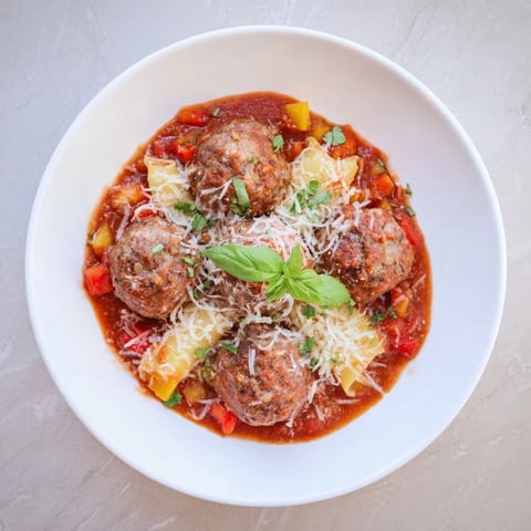 Italian Meatball Pasta Skillet, a bubbling photo of pasta, meatballs, and melted cheese, ready to eat.