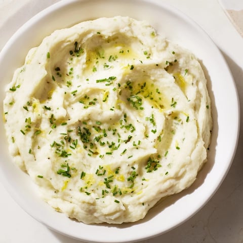 Creamy cauliflower mash with garlic and lemon, served hot, a delicious low-carb side.