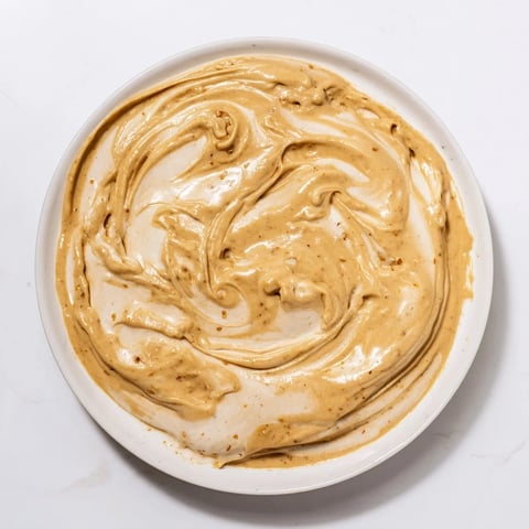 Creamy Peanut Butter Banana Ice Cream swirled with smooth peanut butter, ready to scoop and enjoy.