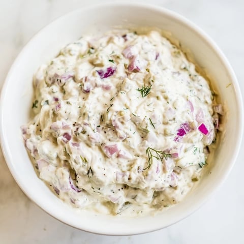 Creamy sweet and sour pickle relish dip with visible relish pieces, perfect for a party appetizer.