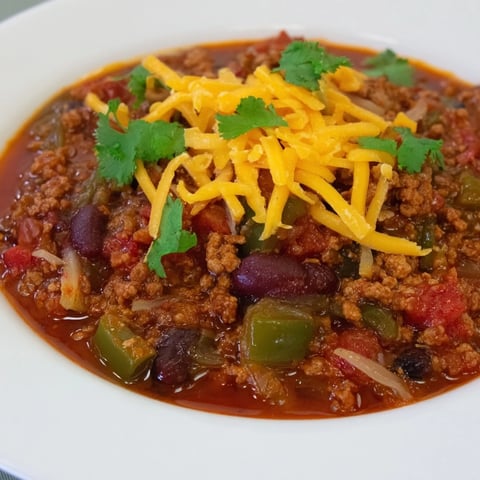 Steaming Quick Chili with canned beans and diced tomatoes, a hearty meal, topped with fresh cilantro.