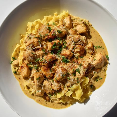 Creamy Cowboy Butter Chicken Pasta: a close-up shows the rich sauce coating perfectly cooked pasta and chicken.