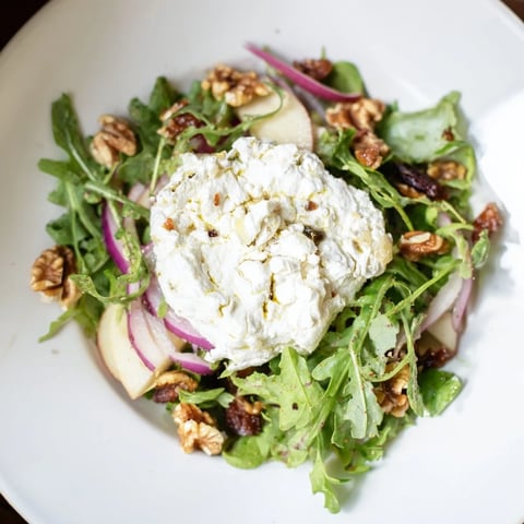Creamy goat cheese and sweet dates star in this Spiced Honey and Date Goat Cheese Salad photo.