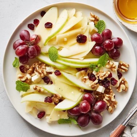 Apple Orchard Fruit Board: a colorful assortment of fresh apples, grapes, and cheese, ready to be enjoyed.