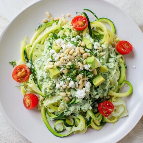 Vibrant Green Goddess Zoodle Pasta garnished with fresh herbs and creamy avocado, ready to serve.