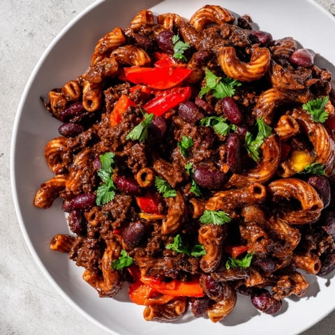 Steam rising from a bowl of one-pot ditalini with hot cocoa chili, ready to eat.