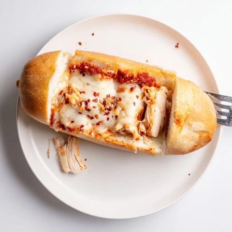 Golden-baked Chicken Parm Stuffed Garlic Bread boats overflow with melted mozzarella and rich marinara.