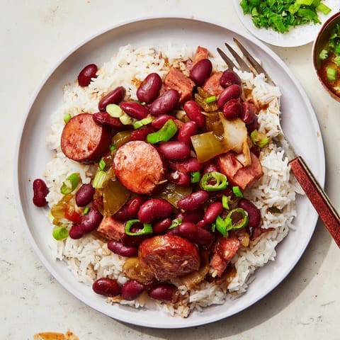 Hearty Red Beans & Rice featuring tender beans and smoky sausage over fluffy rice.  