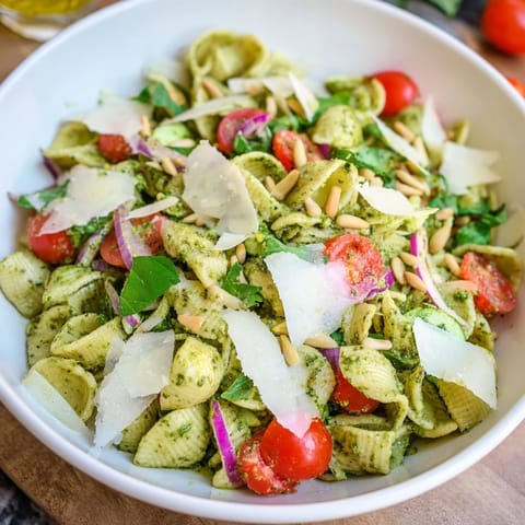 A beautiful bowl of Caesar Pesto Ditalini Salad featuring al dente pasta plus fresh veggies and pesto dressing.