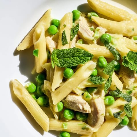 Savory strips of golden chicken breast and al dente penne are coated in a bright, buttery lemon sauce with pops of green peas.