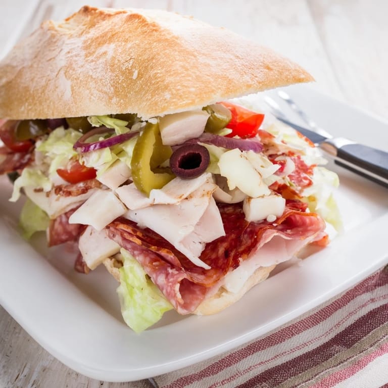 Delicious Flavor Mash-Up Sandwiches drizzled with tangy dressing and colorful toppings.  