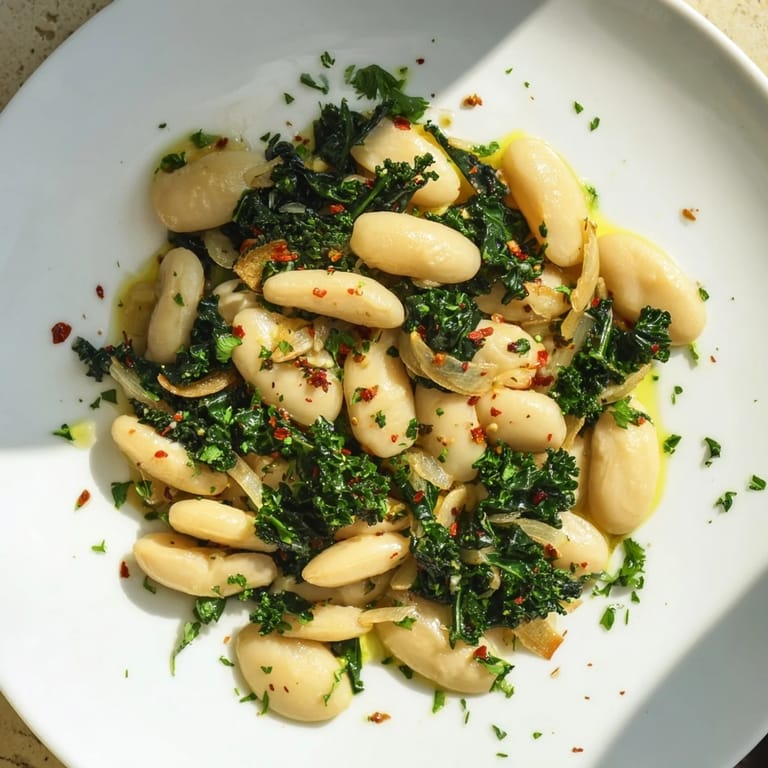 Close-up of Garlicky Beans with Winter Greens: showcasing tender greens and the fragrant garlic infused beans.
