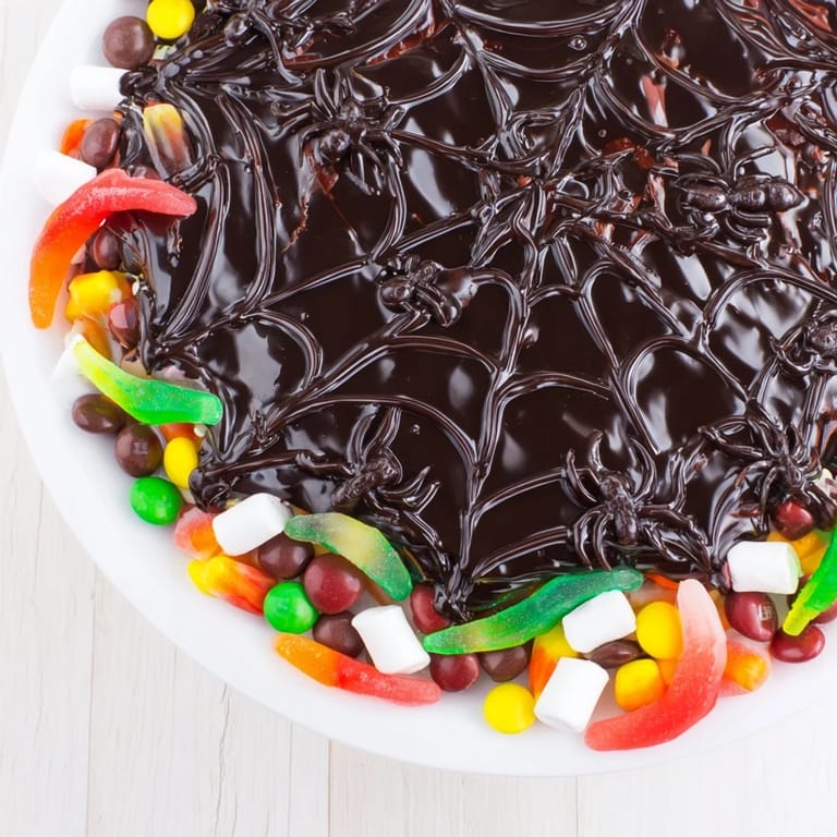 Delicious and spooky homemade spiderweb candy platter, perfect for a Halloween dessert arrangement.