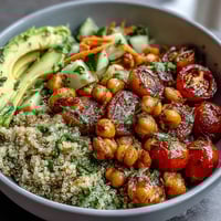 Fresh lemon vinaigrette grain bowls with roasted chickpeas, colorful vegetables, and fluffy quinoa for a healthy, vibrant meal.  